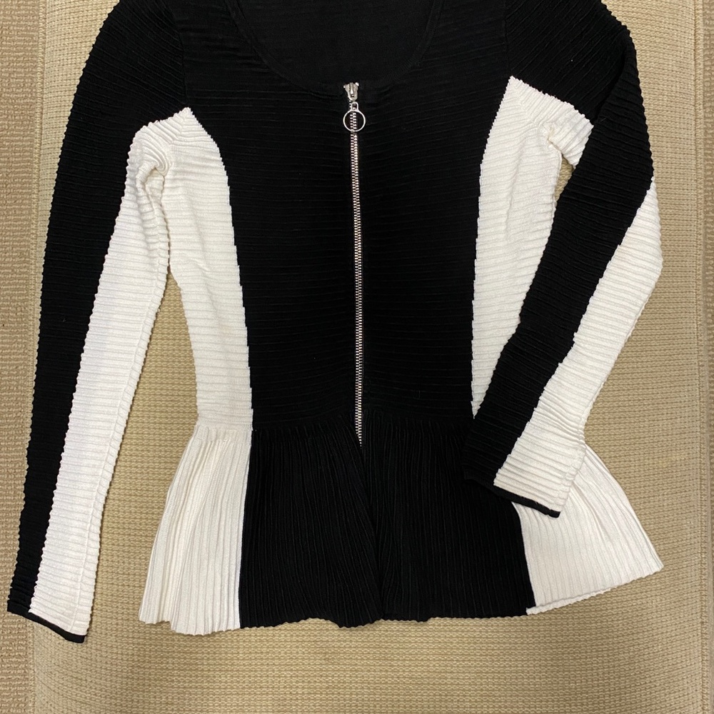 Black and white peplum zipper sweater.